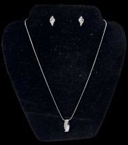 An 18ct white gold necklace suspending an 18ct white gold diamond encrusted pendant, diamonds