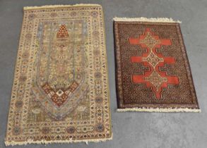 A cream ground Persian style rug with geometric designs to the border and floral designs to the