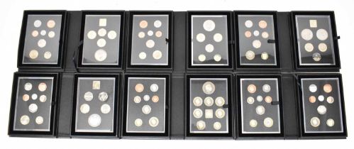 A set of commemorative proof coin sets from 1985 to 2023, missing 1987, 1988, 2000, 2017, 2019, 2020