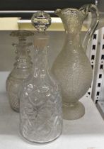 A late 19th century crackle glass claret jug and two cut glass decanters (3).