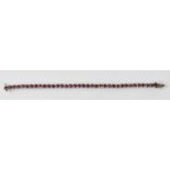 A white metal ruby set tennis bracelet, rubies totalling approx 3.5ct, length 16.5cm, approx 11.5g.
