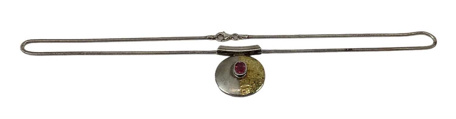 A 925 hallmarked silver ruby pendant, the central ruby approx 0.6ct, suspended on a 925 hallmarked