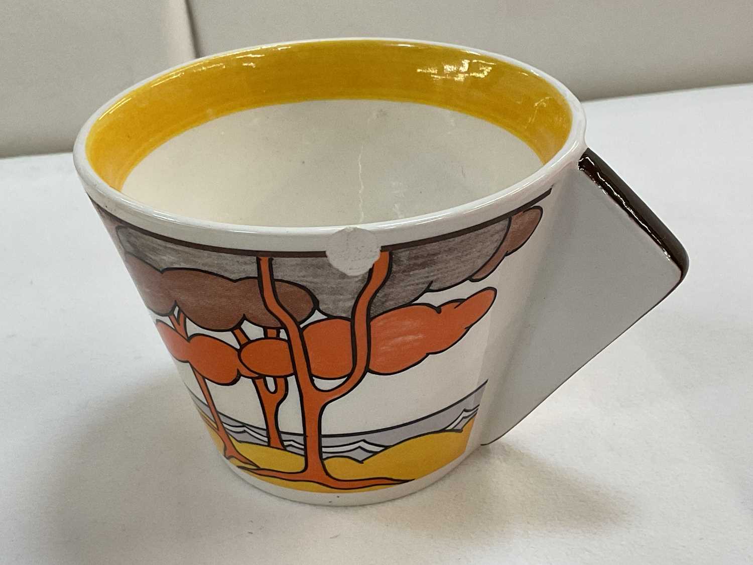 BRADFORD EXCHANGE; a Clarice Cliff 'Bizarre' painted 'Trees and House' pattern teacup and saucer, - Image 3 of 4