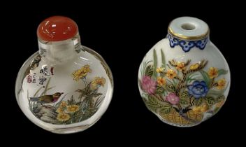 A Chinese glass scent bottle with floral painted decoration and red hardstone top, height 6cm, and a