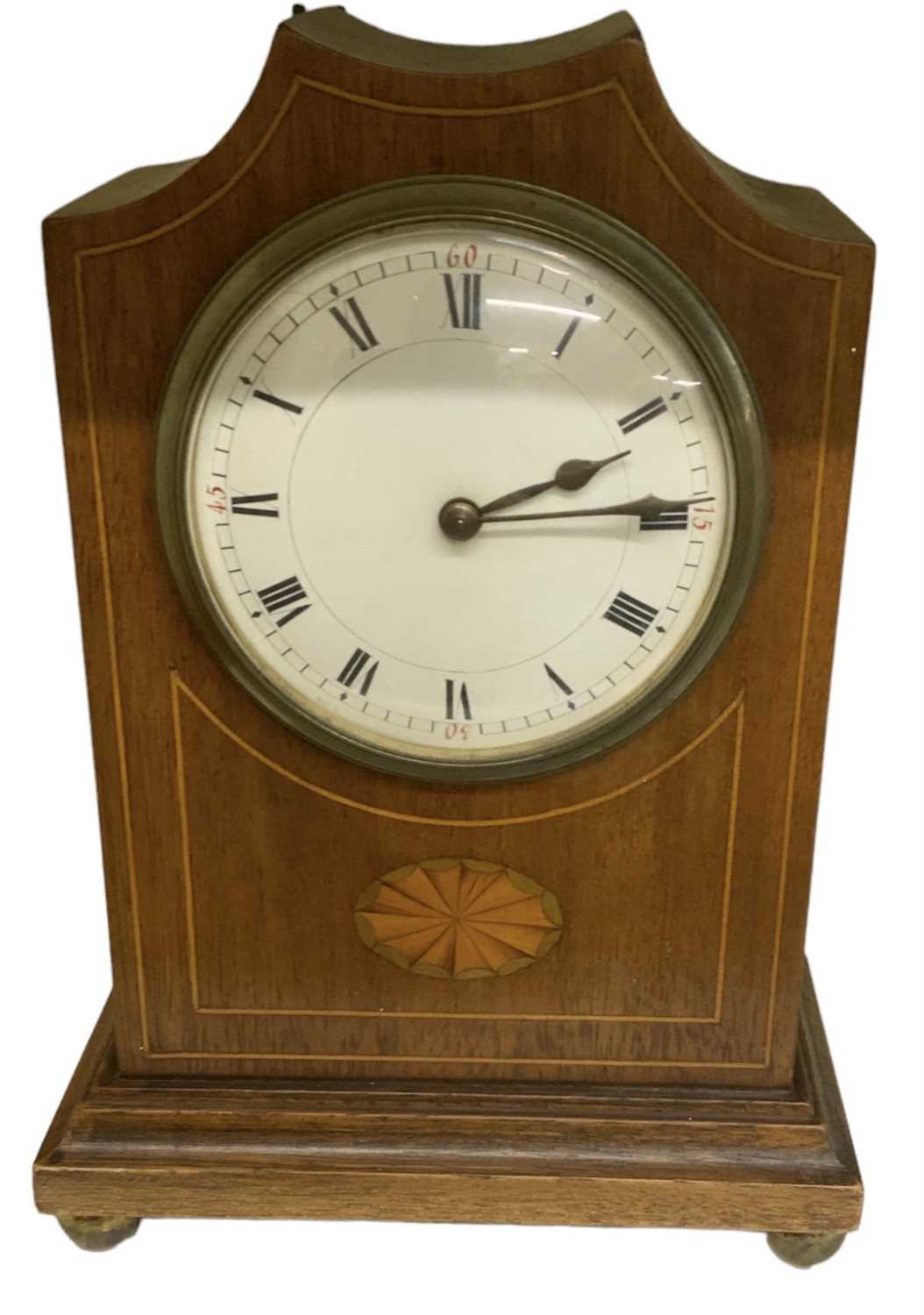 An Edwardian mahogany and inlaid mantel clock, the white enamel dial set with Roman numerals, height