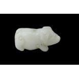 A Chinese carved white hardstone figure of a pig, height 2.5cm, length 4.5cm (with drill hole to the