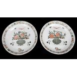 A pair of large Kangxi (1662-1722) Famille Verte chargers, each painted with a central vase of