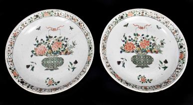 A pair of large Kangxi (1662-1722) Famille Verte chargers, each painted with a central vase of