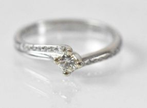 A 14ct white gold diamond solitaire ring, the central stone approx 0.15ct, size N, approx 3.1g.