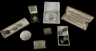 A quantity of costume jewellery including pearls, brooches, marcasite brooches, compacts, etc.