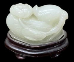 A Chinese jade modelled as a bird, on hardwood base, height 5cm, length 5.5cm.