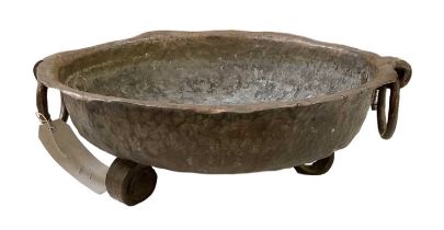A large copper twin handled bowl, diameter 45cm.