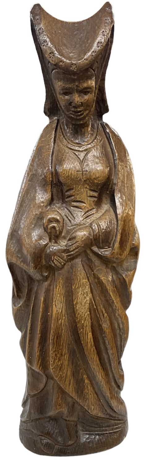 An early 20th century oak model of the Virgin Mary in the ancient style, height 44cm.