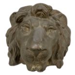 A bronze wall mounted figure of a lion's head, width 15cm, height 16cm.