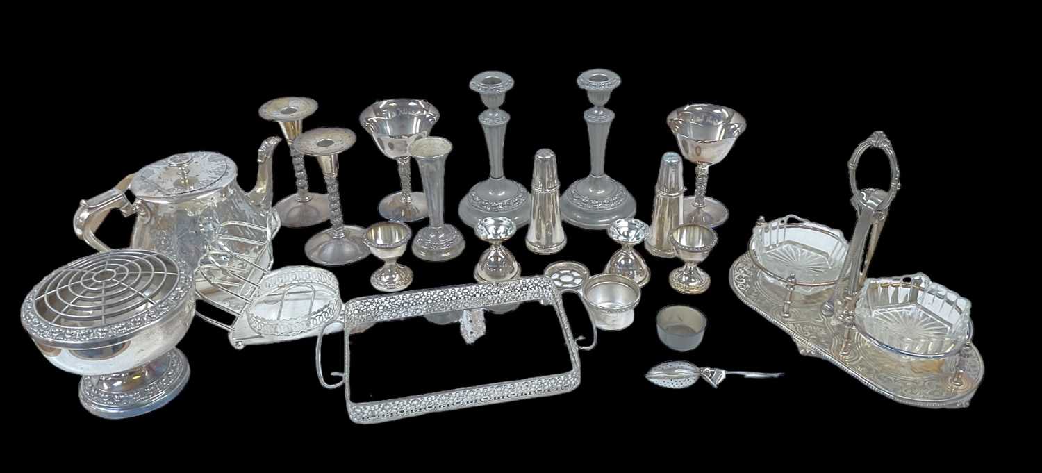 A quantity of plated items including teapot, rose bowl, vases, candlesticks, twin handled tray,