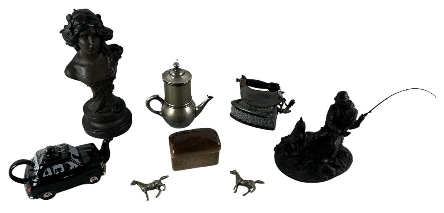 A group of collectors' items including two cast iron kettles, a brass kettle, an enamel kettle, an