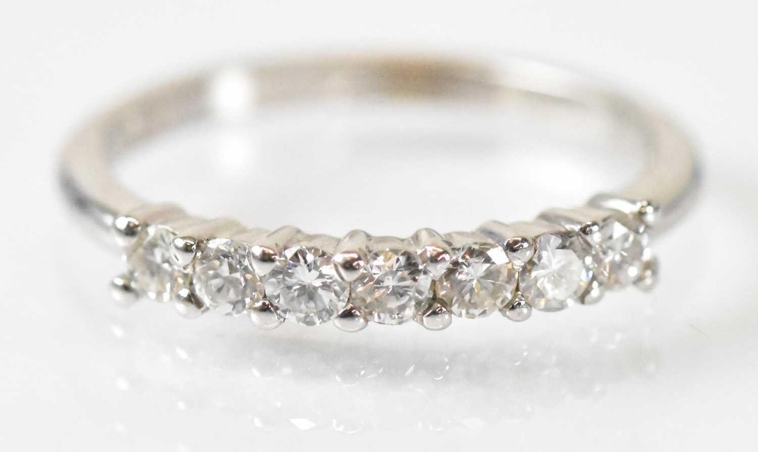 An 18ct white gold seven stone diamond ring, size K/L, approx 2.7g.