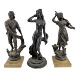 Two cast metal figures on hardstone bases, one depicting a sailor pulling a fish from the sea, the