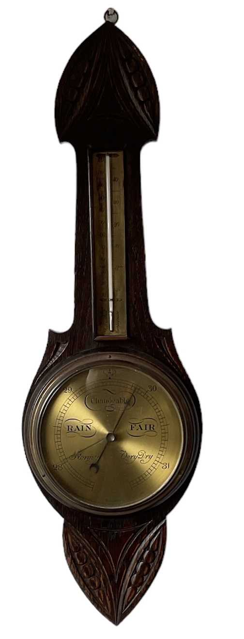 A 20th century carved oak barometer, height 83cm (af).