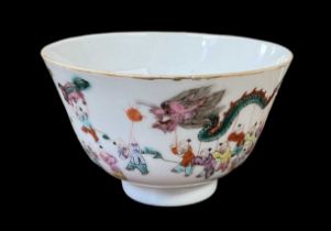 A Chinese porcelain tea bowl decorated with figures and dragons, bearing a Qianlong mark to base,