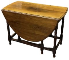 An early 20th century oak drop-leaf gateleg dining table, width 102cm.