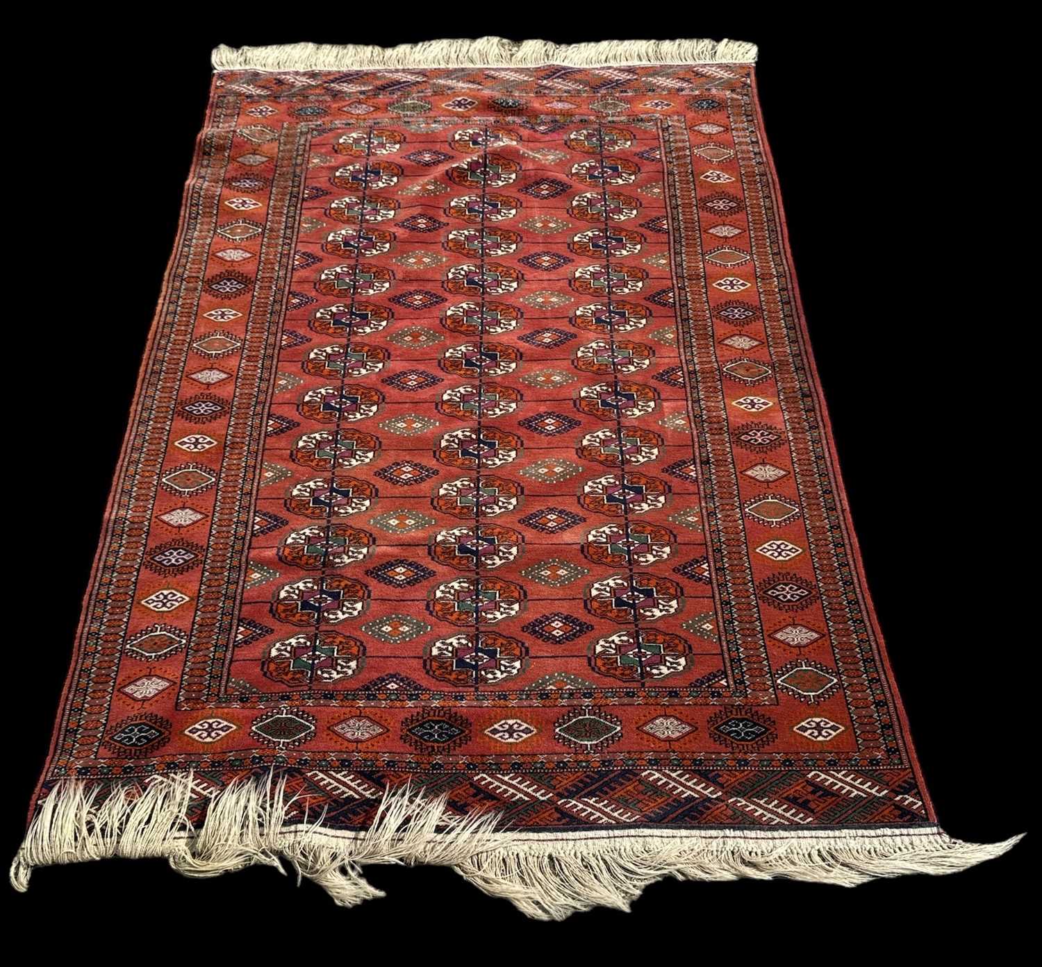 A modern red ground Persian style carpet with geometric design, 196 x 129cm.
