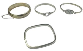 A group of four 925 hallmarked silver bangles, combined approx 63g.
