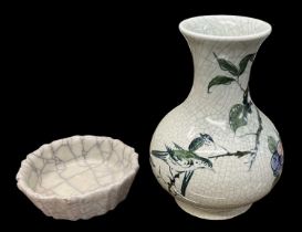 A modern Chinese celadon glazed floral decorated vase, height 18.5cm, and a celadon glazed brush