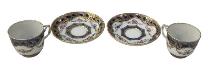 A pair of unusual 18th century Chinese export ware cobalt blue and gilt decorated floral teacups and