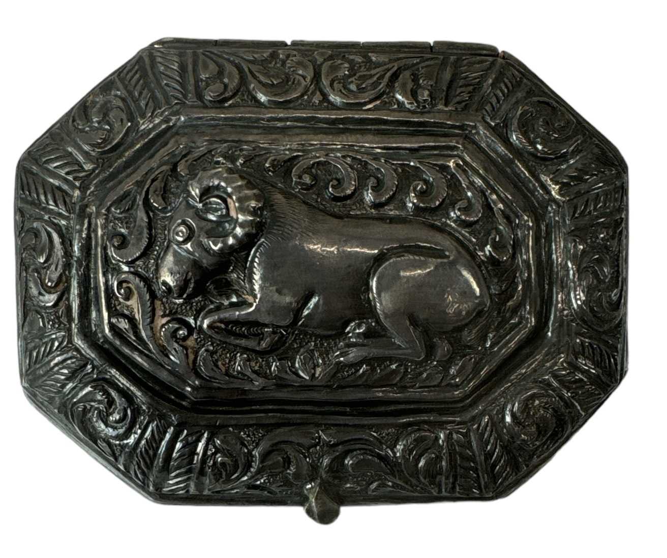An Indian white metal snuff box of canted rectangular form and decorated with beasts, 6 x 5cm,