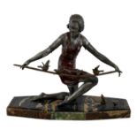 G ARISSE; a 1930s Art Deco bronze figure of a lady feeding the birds, raised on a marble base,