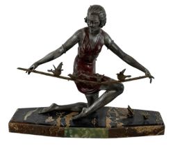 G ARISSE; a 1930s Art Deco bronze figure of a lady feeding the birds, raised on a marble base,