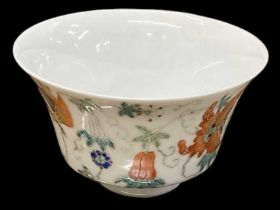 A late 19th century Chinese footed bowl externally enamel painted with butterflies amongst fruit,