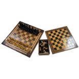 A cased Staunton chess set, another cased chess set, a games box and a chessboard, 39 x 39cm.