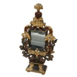 An elaborate gilt wood framed table top dressing mirror, with heart motif to the top and ancient