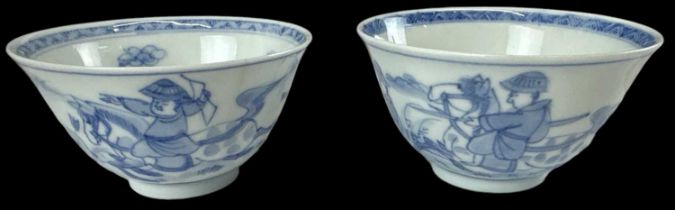 A pair of Chinese blue and white tea bowls decorated with figures upon horseback, diameter 9cm.