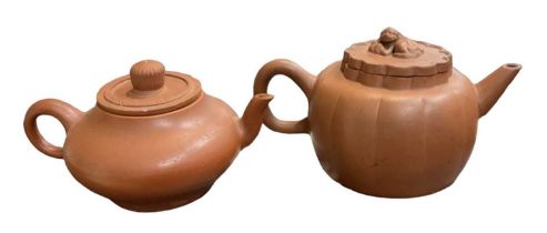 Two Chinese Yixing teapots, one with monkey decoration to the lid, the other with seven character