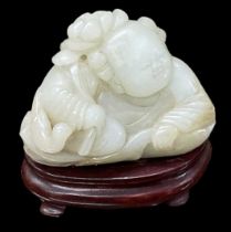 A Chinese carved hardstone modelled as a Buddha, on hardwood base, height 6cm, length 6cm.