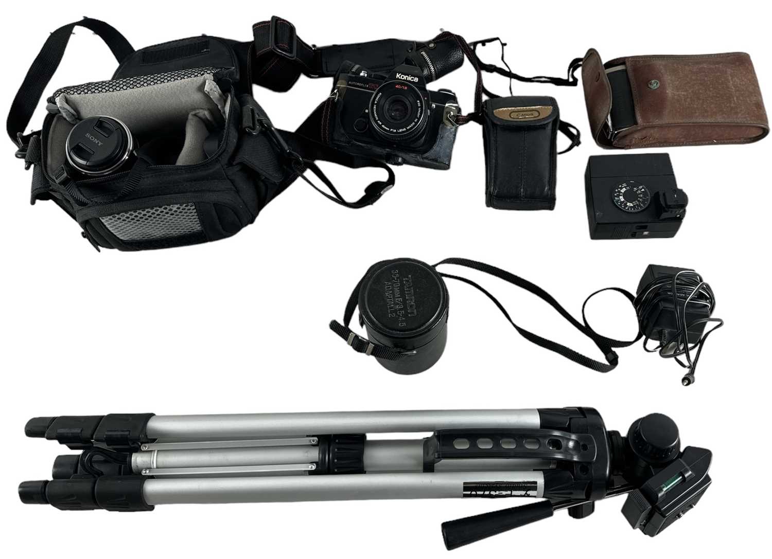 A group of cameras, equipment and lenses including a Konica Autoreflex TC camera, a Sony NEX-3 HD