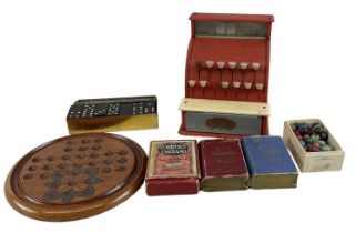 CODEG; a vintage miniature child's cash register, a solitaire set with marbles, a set of dominoes