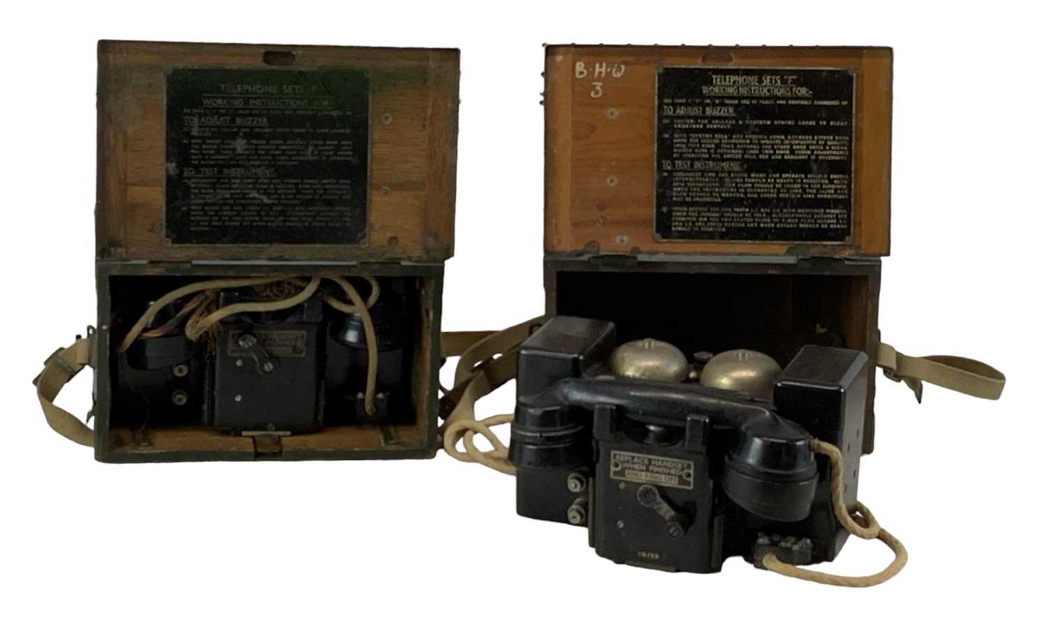 A pair of British WWII field telephones (both cased).