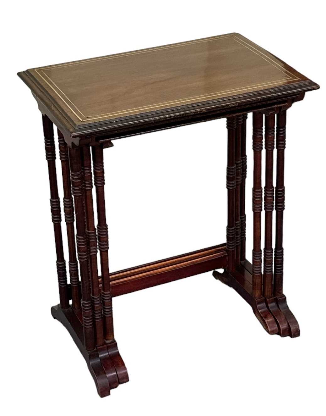 A nest of three mahogany and brass inlaid occasional tables, top 57 x 39cm.