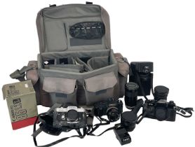 A quantity of cameras, lenses and equipment including a Canon FTb, Canon F-1, Canon T50 and two