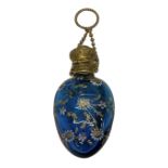 A 19th century hand painted glass scent bottle with floral decoration and brass lid, suspended on