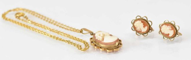 A pair of 9ct yellow gold cameo set earrings and a yellow metal mounted cameo pendant on yellow