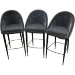 A set of three modern contemporary button back upholstered bar stools, on black metal supports,