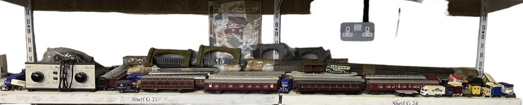 A large quantity of assorted model railway track and rolling stock, including Pullman carriages etc,