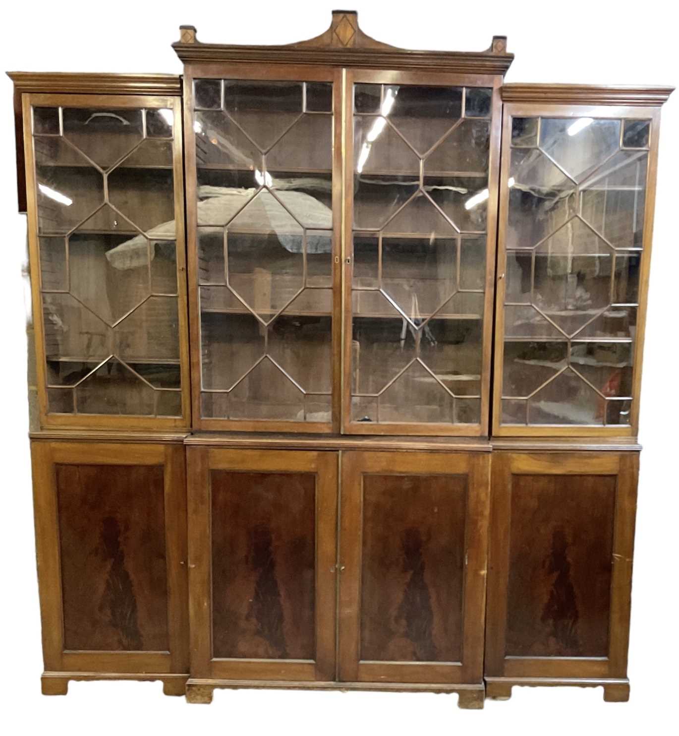 A good large 19th century breakfront bookcase, the glazed doors enclosing an arrangement of