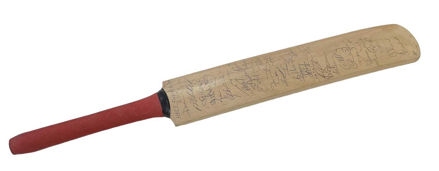 A cricket bat signed by the 2004 Lancashire Cricket Club team, including Andrew Flintoff, James