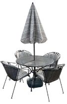 A modern wrought iron circular garden table, diameter 105cm, together with four chairs, umbrella and